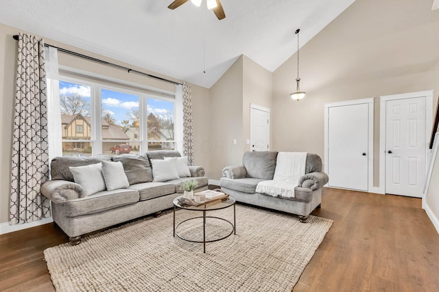 living room featuring ceiling fan, high vaulted ceiling, and hardwood / wood-style flooring