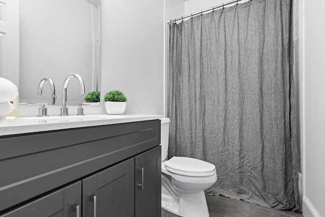 bathroom featuring tile patterned floors, toilet, and vanity