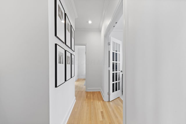 hall featuring crown molding and light wood-type flooring