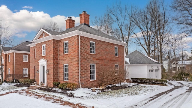 view of snowy exterior featuring a garage