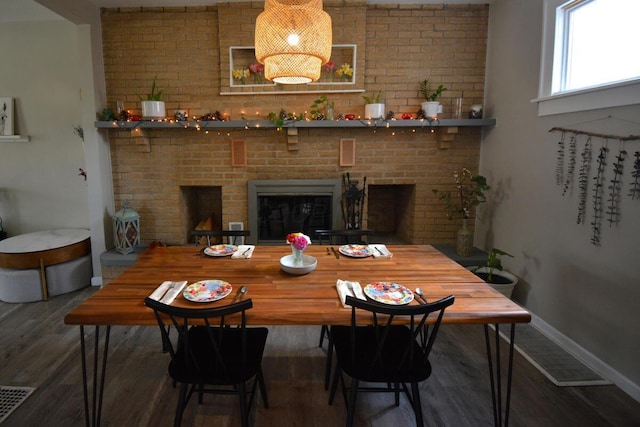 dining room with visible vents, baseboards, and wood finished floors