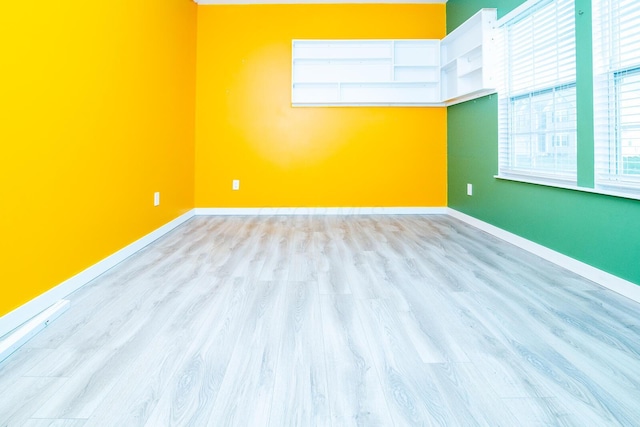 unfurnished room featuring light hardwood / wood-style floors