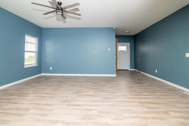 unfurnished room with light wood-type flooring and ceiling fan