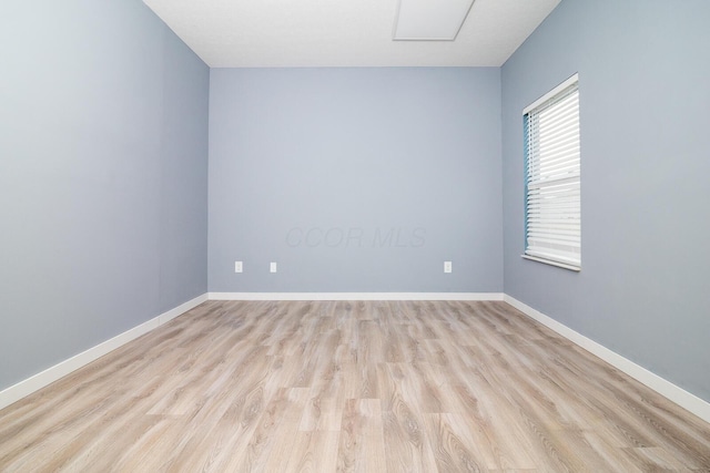 spare room with light hardwood / wood-style flooring