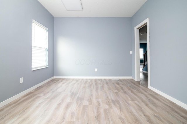 empty room with light hardwood / wood-style flooring