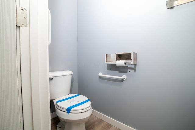 bathroom featuring hardwood / wood-style floors and toilet