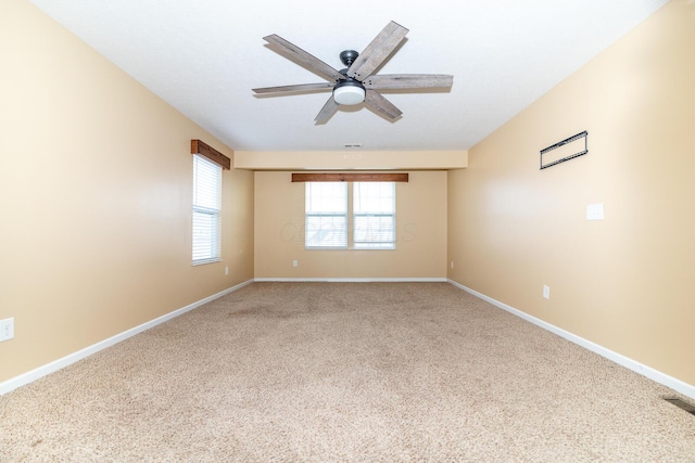 carpeted empty room featuring ceiling fan