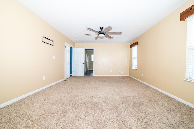 empty room featuring carpet flooring and ceiling fan