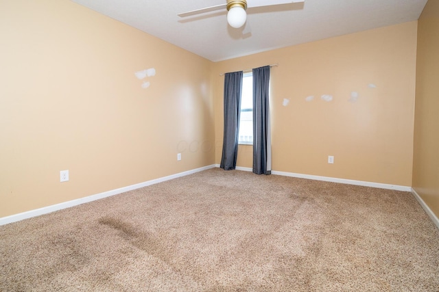 carpeted spare room featuring ceiling fan