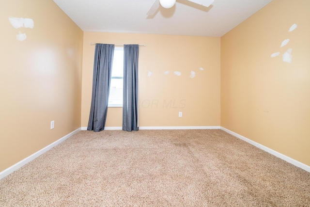 carpeted empty room featuring ceiling fan