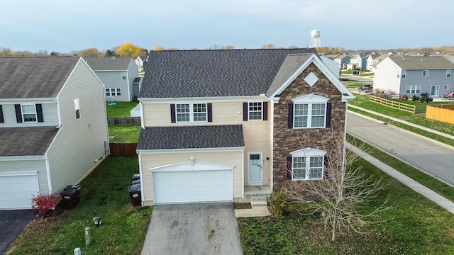 view of front facade featuring a front yard and a garage