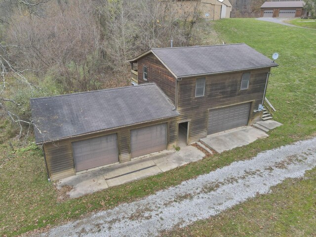 exterior space featuring a garage and a front lawn