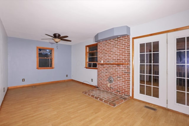 unfurnished living room featuring light hardwood / wood-style floors and ceiling fan