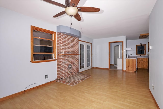 unfurnished living room with ceiling fan and light hardwood / wood-style flooring