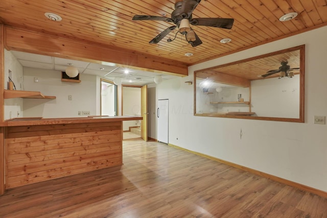 empty room with ceiling fan, wood ceiling, ornamental molding, and light hardwood / wood-style flooring