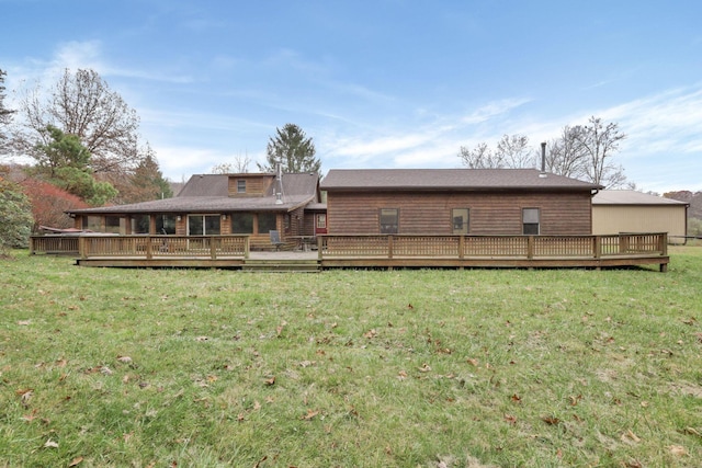 rear view of house with a wooden deck and a yard