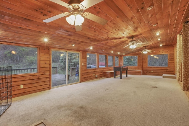 interior space featuring light carpet, wooden walls, and wooden ceiling