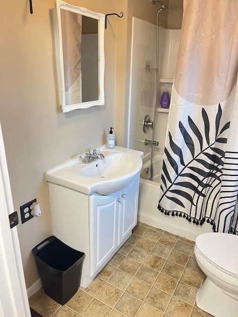 full bathroom with tile patterned flooring, vanity, toilet, and shower / bath combo with shower curtain