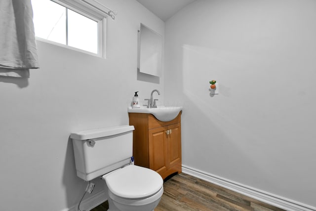 bathroom with vanity, toilet, and wood-type flooring