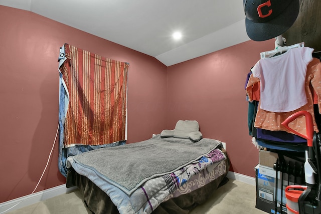 carpeted bedroom with vaulted ceiling