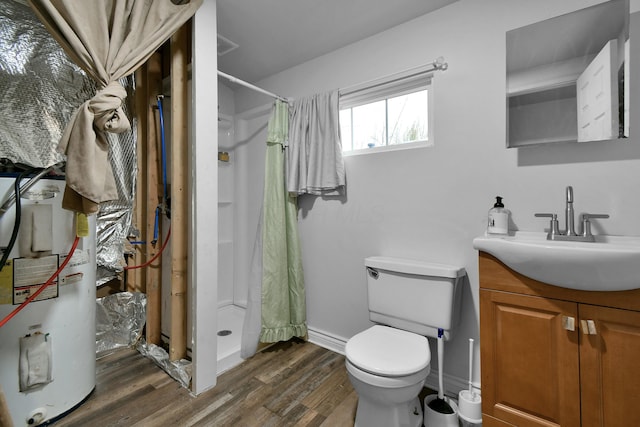 bathroom with curtained shower, electric water heater, hardwood / wood-style floors, toilet, and vanity