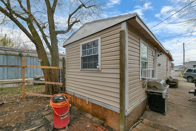 view of home's exterior with an outbuilding and cooling unit