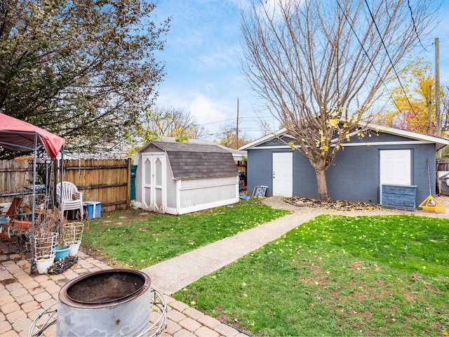 view of yard with a gazebo, a storage unit, an outdoor fire pit, and a patio