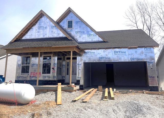 property under construction with a shingled roof and an attached garage