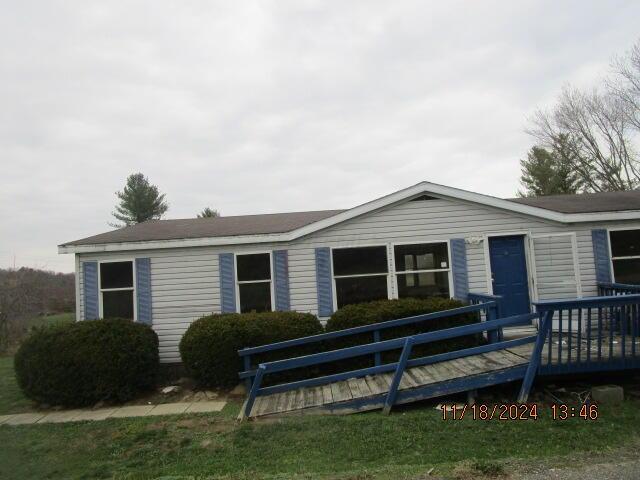 view of front of property with a wooden deck