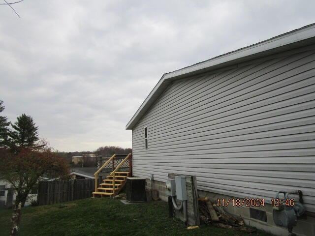 view of side of property with central air condition unit