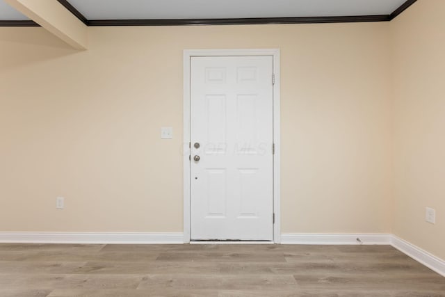 interior space featuring light hardwood / wood-style floors and ornamental molding