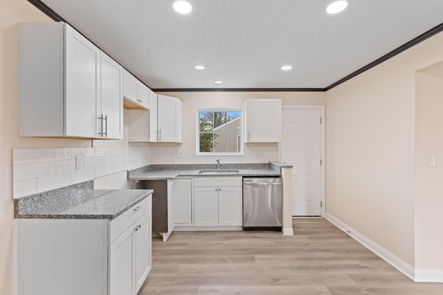 kitchen featuring white cabinets, dishwasher, sink, and light hardwood / wood-style flooring