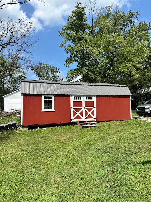 view of outbuilding featuring a lawn