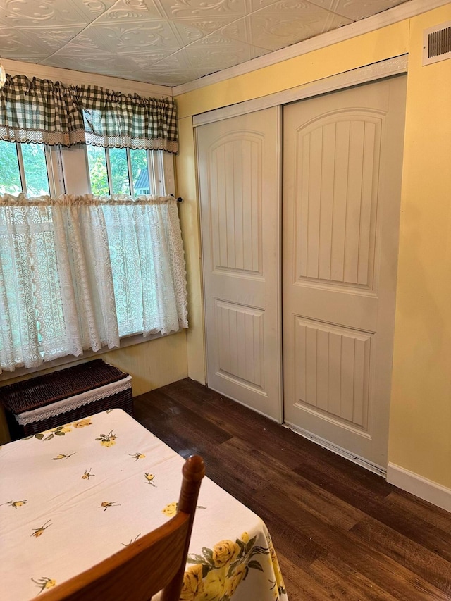 unfurnished bedroom featuring a closet and dark wood-type flooring