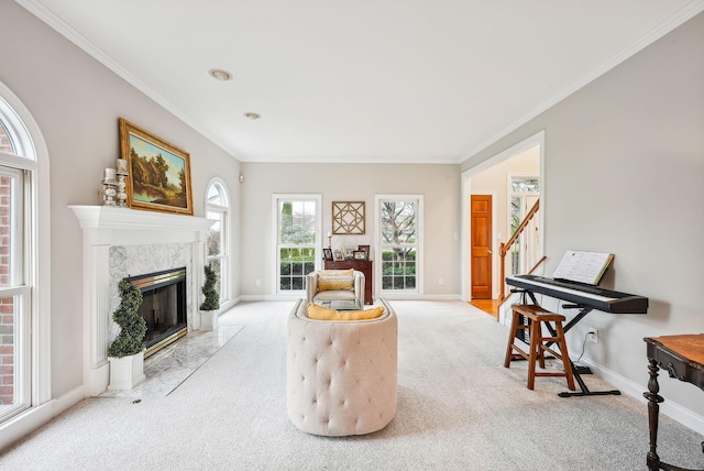 sitting room featuring light colored carpet, a premium fireplace, and ornamental molding