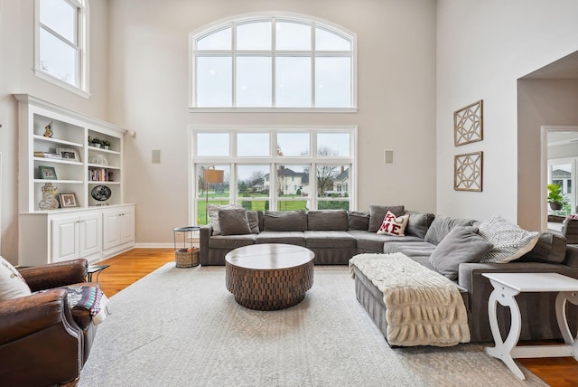 living room featuring hardwood / wood-style floors and a towering ceiling