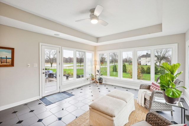 sunroom / solarium featuring ceiling fan