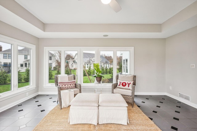 sunroom featuring ceiling fan and a healthy amount of sunlight