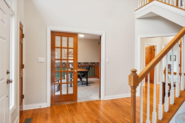 entryway featuring wood-type flooring and french doors