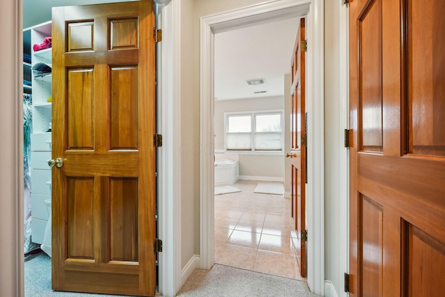 corridor featuring light tile patterned floors