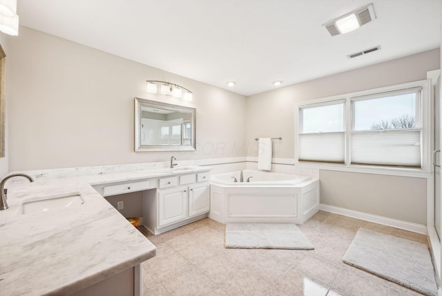 bathroom with a washtub and vanity