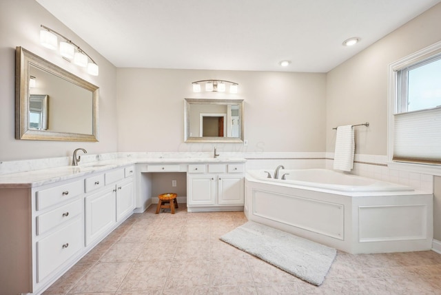 bathroom featuring tile patterned floors, vanity, and a bath