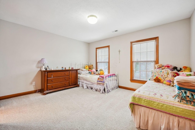 carpeted bedroom featuring a textured ceiling