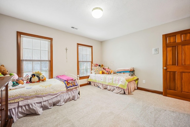 bedroom with a textured ceiling and carpet floors