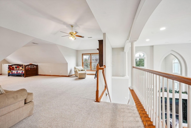 interior space with carpet flooring and ceiling fan