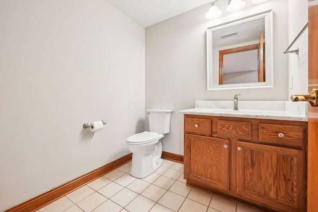 bathroom with tile patterned flooring, vanity, and toilet