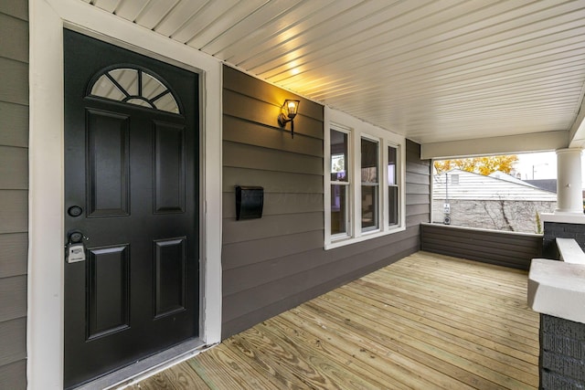 view of exterior entry featuring a porch