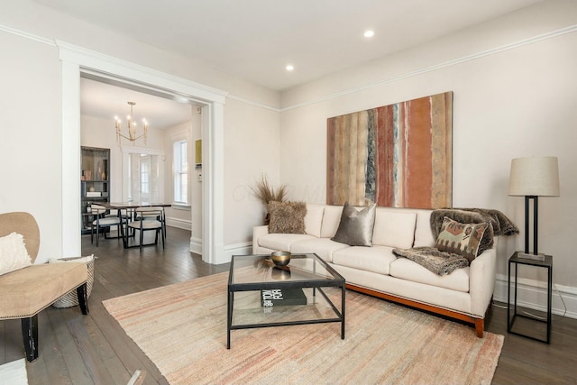 living room featuring wood-type flooring and a chandelier