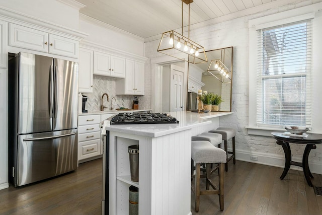 kitchen with white cabinets, stainless steel appliances, and a wealth of natural light