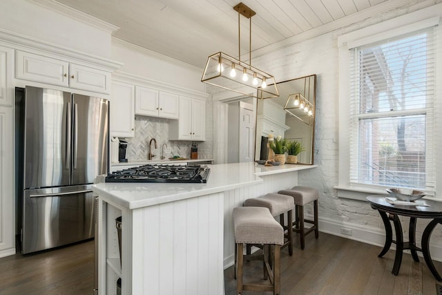 kitchen featuring white cabinetry, stainless steel refrigerator, and dark wood-type flooring